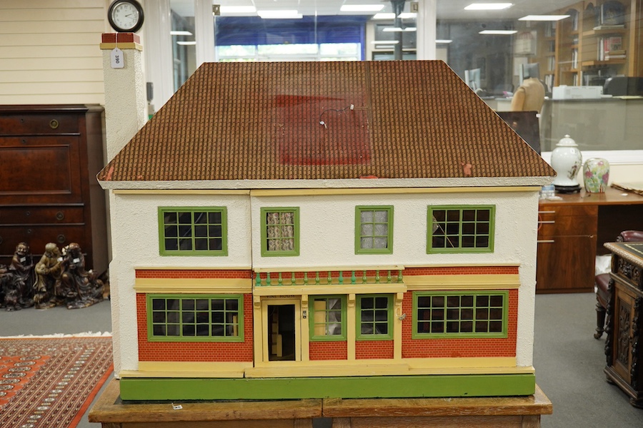 A modern ‘Vine House’ dolls house with furniture and accessories; a large six room house with hall and stairwell, the front wall opening in two sections on hinges each side, with internal decoration and lighting, width 1